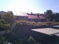 Blocked by houses on the hill above